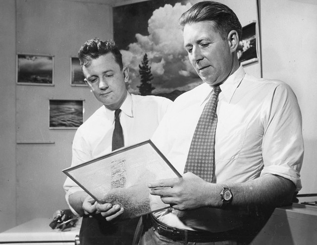 Bernard Vonnegut and Vincent Schaefer examine preserved snowflakes on a sheet of glass in 1951.