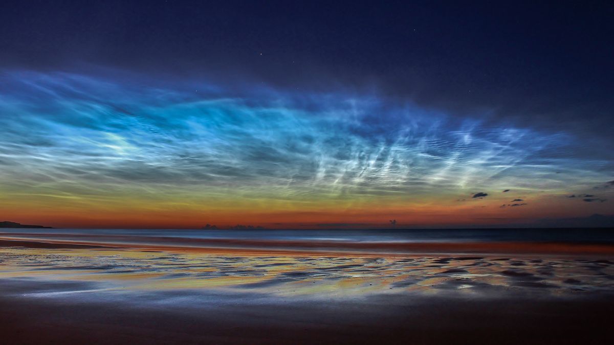 Noctilucent clouds form when water vapor freezes onto dust particles left by meteoroids high in the atmosphere.