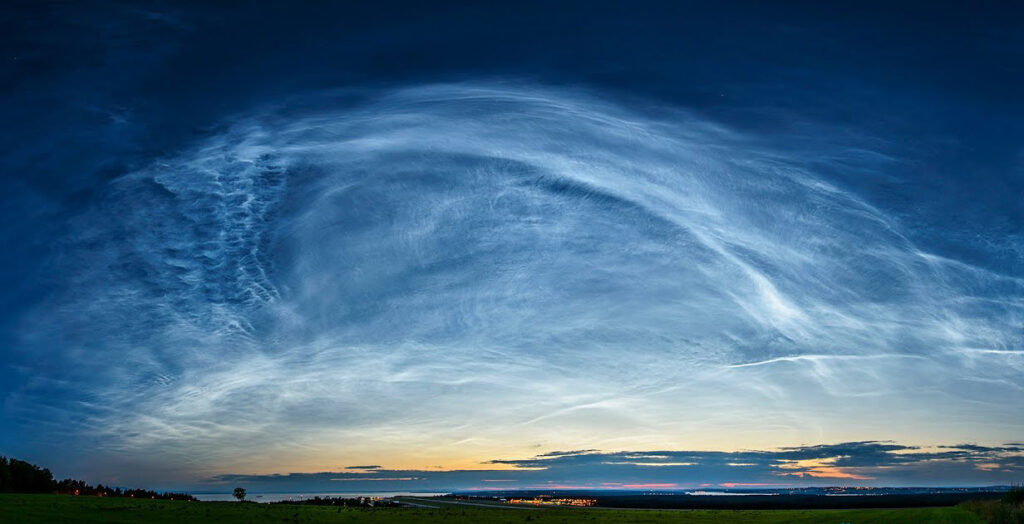 The milky glow of noctilucent clouds.
