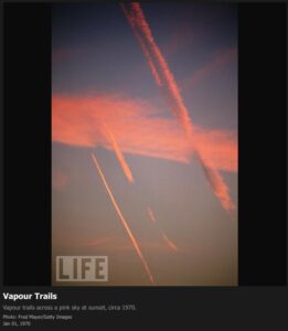 1970 – Contrails across a pink sky at sunset
