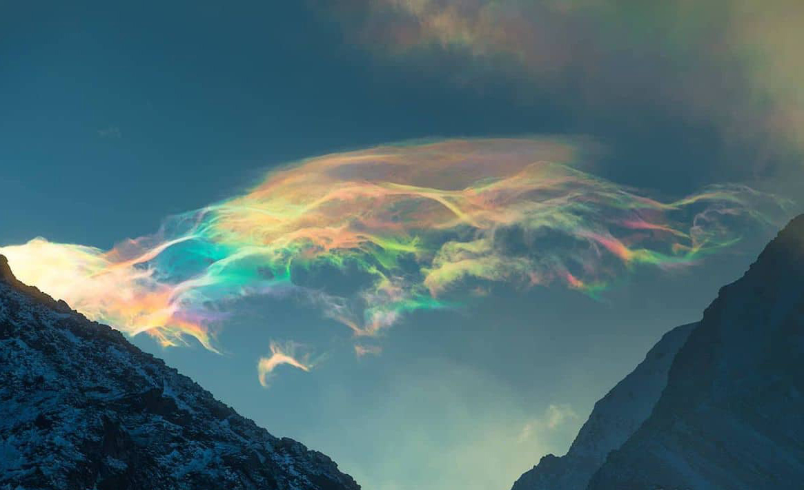 Cloud iridescence behind Siberia's highest peak, Belukha Mountain
