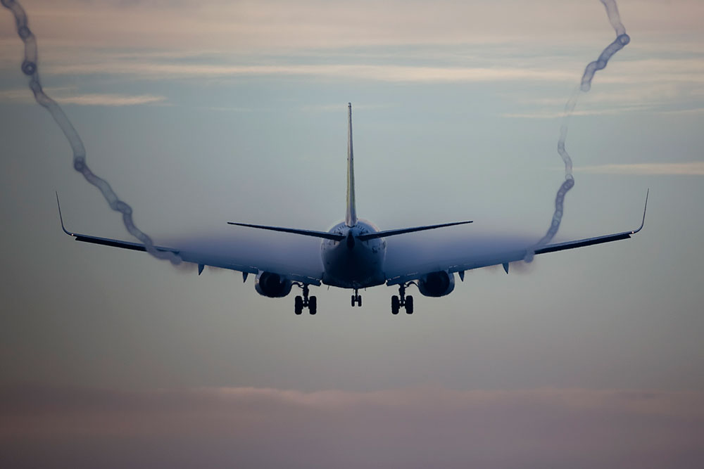 Full Aerodynamic wake contrails appearing over the wings